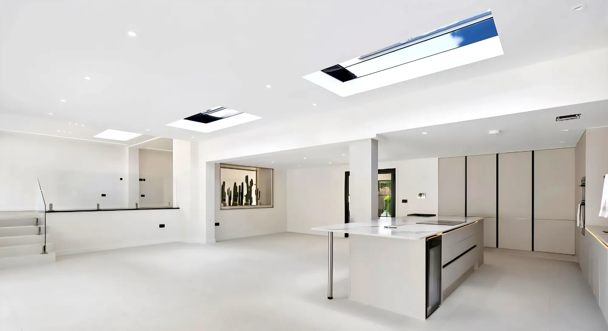 Kitchen with tall units and a roof light above