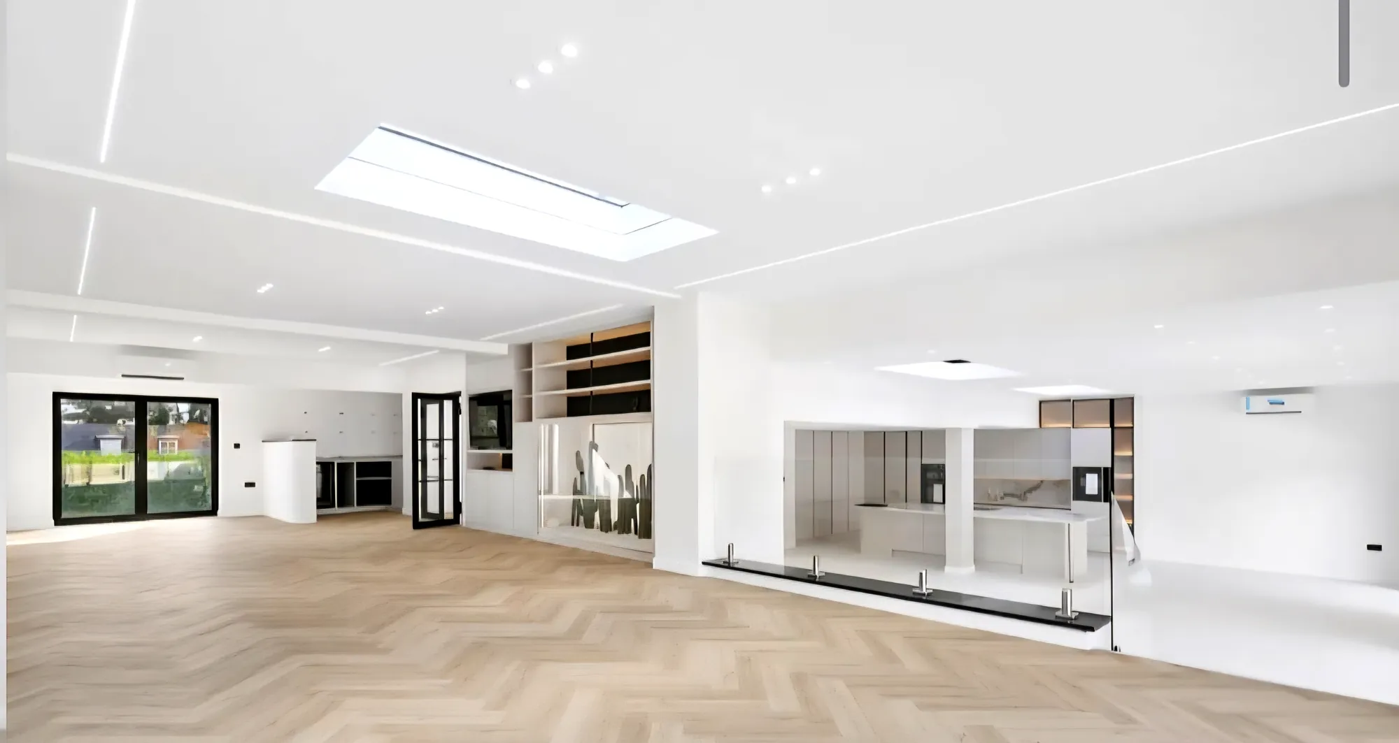 Living space with herringbone flooring and a roof light