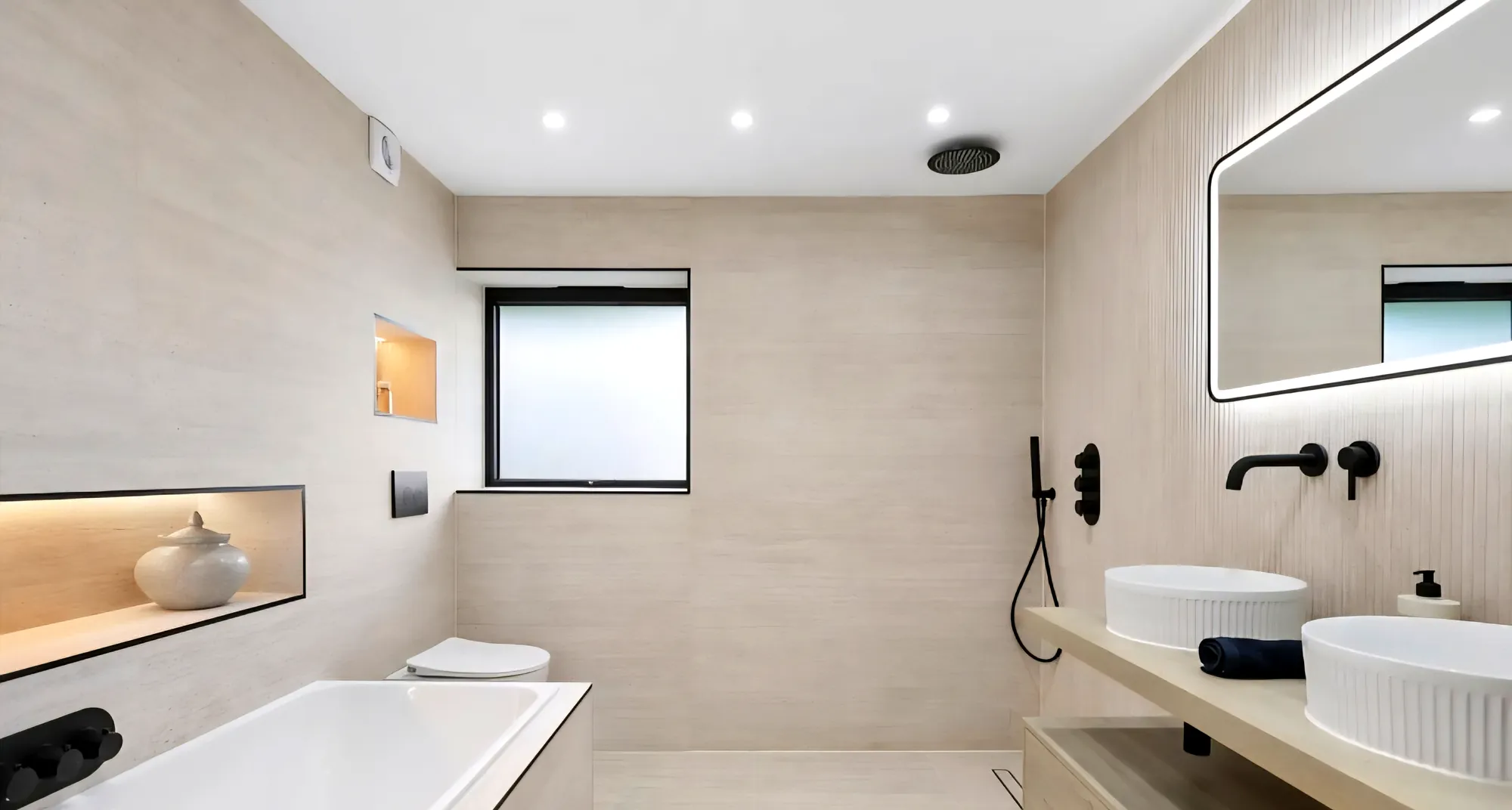 Bathroom with a bath, twin basins and a lit niche