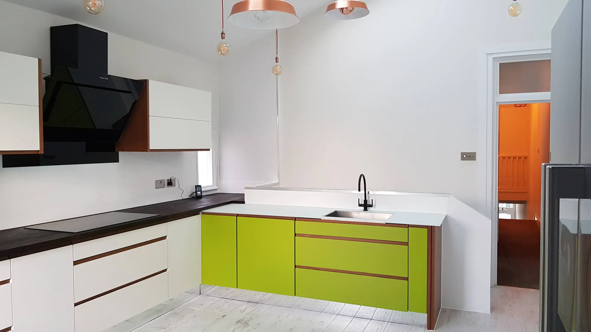 Kitchen with a lime green run of units