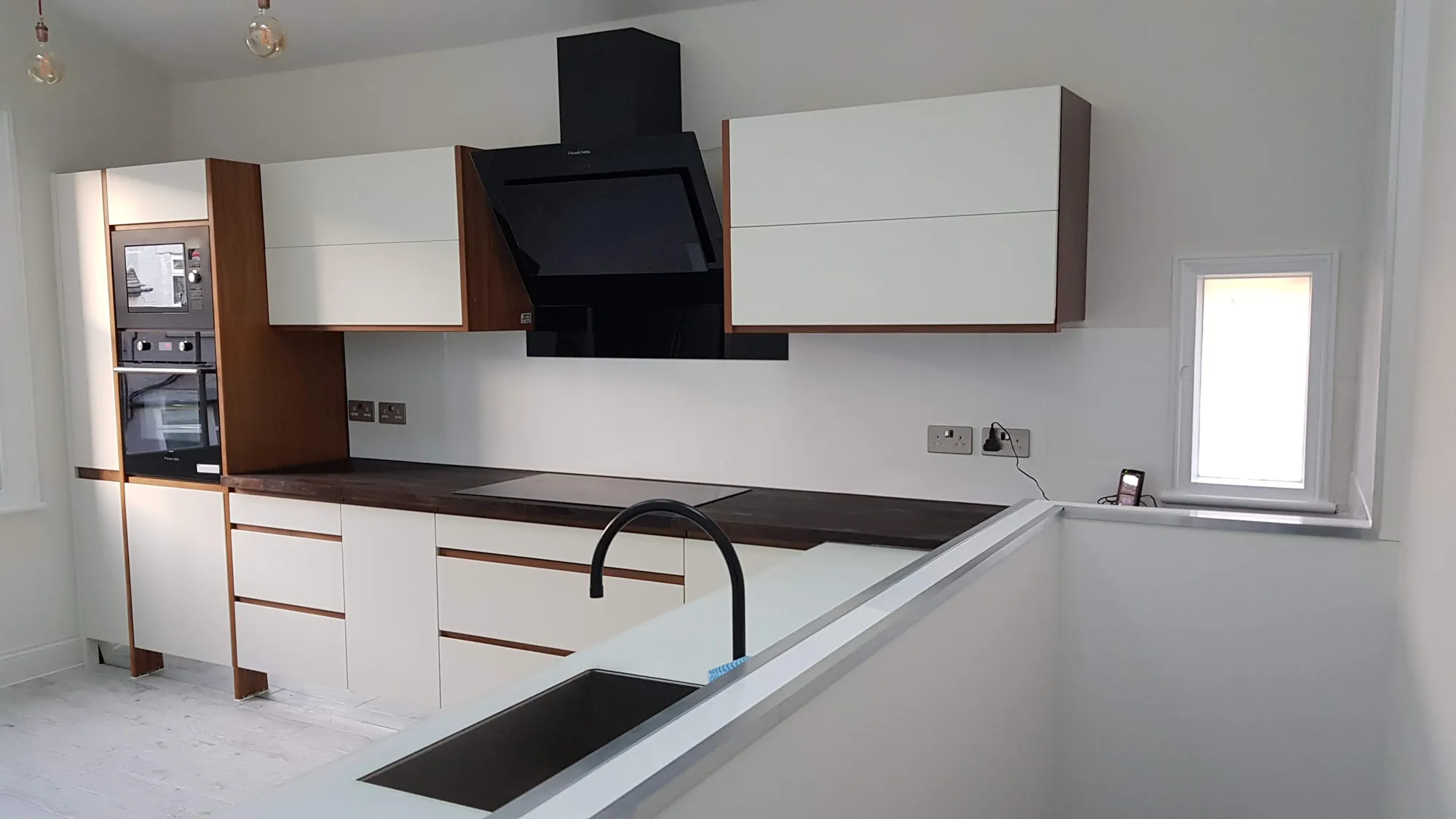 Kitchen with a black extractor hood