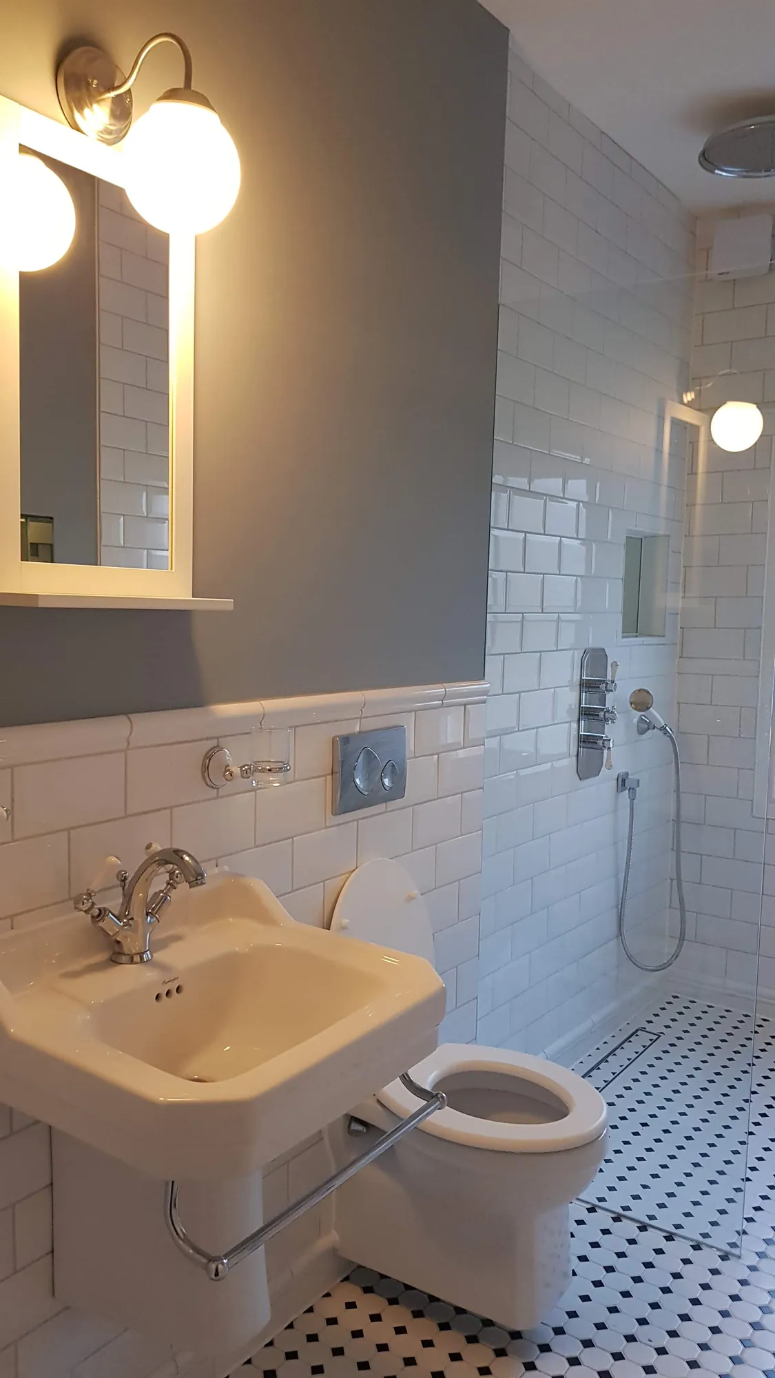 Bathroom with metro tiles and a mosaic floor