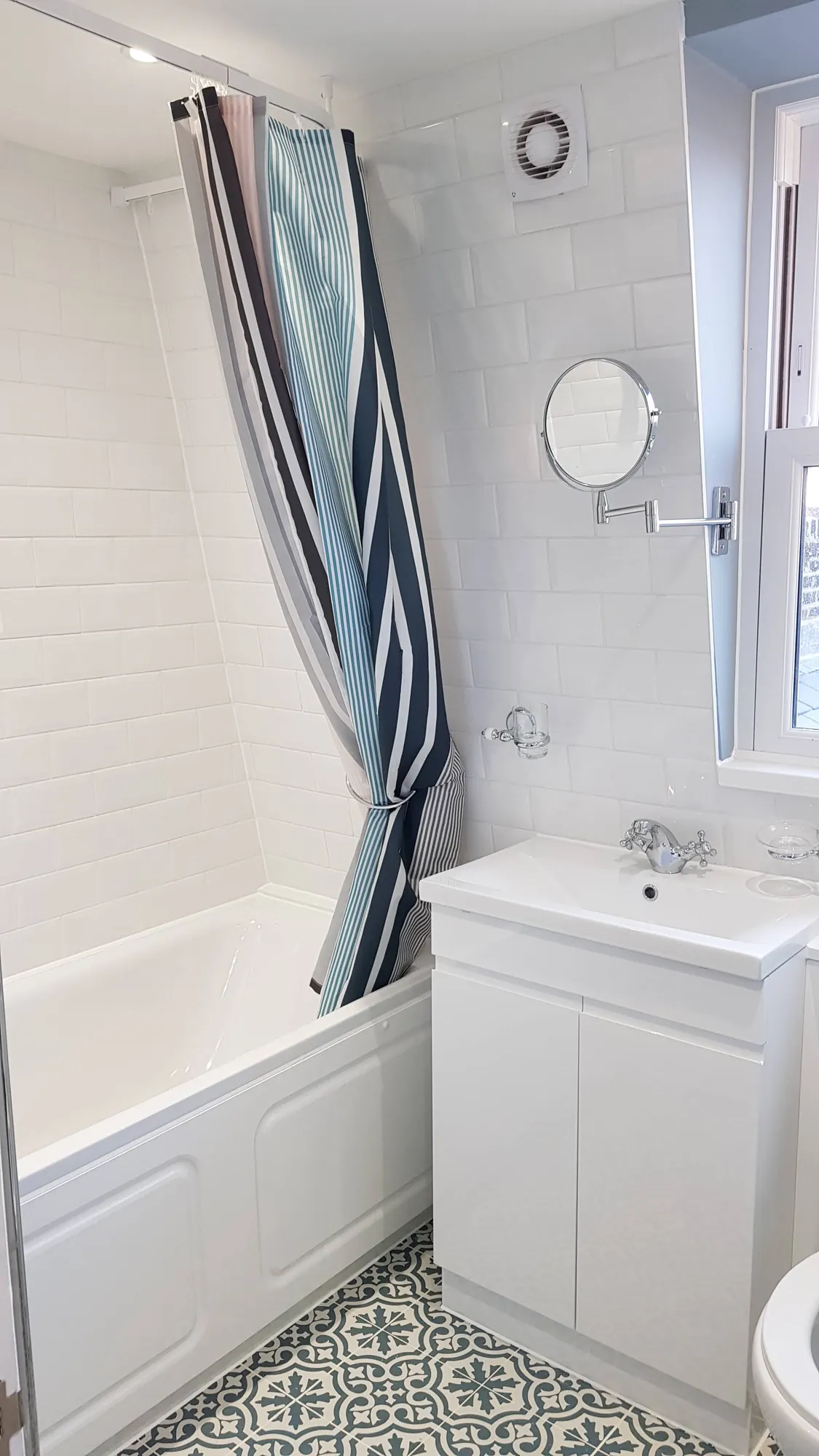 Bathroom with a patterned tile floor