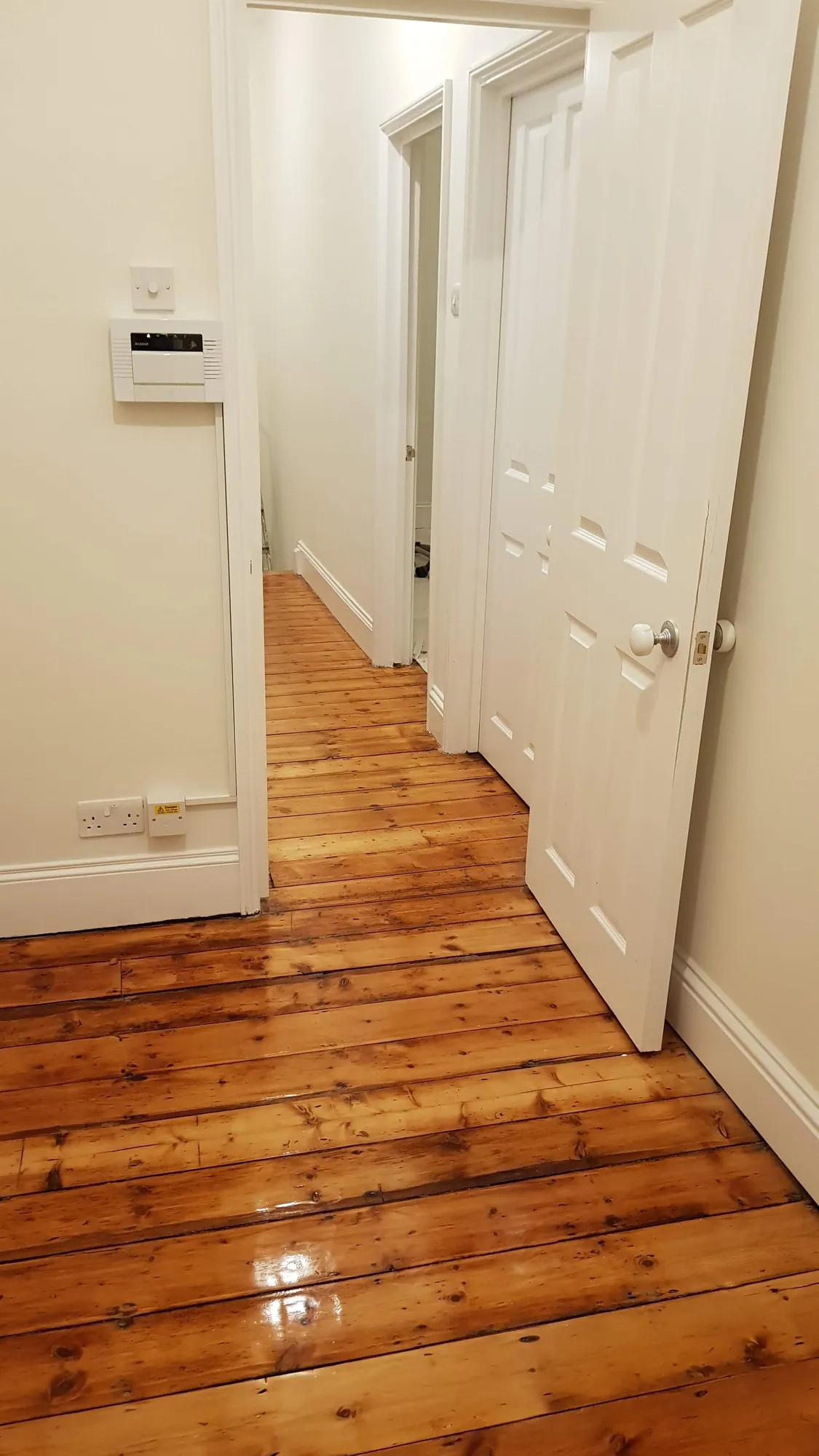The hallway with its original floorboards restored