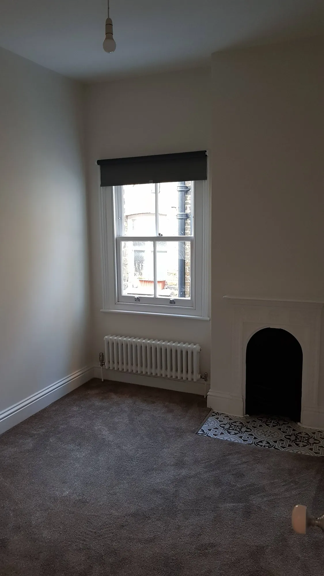 Bedroom with a period fireplace and tiled hearth
