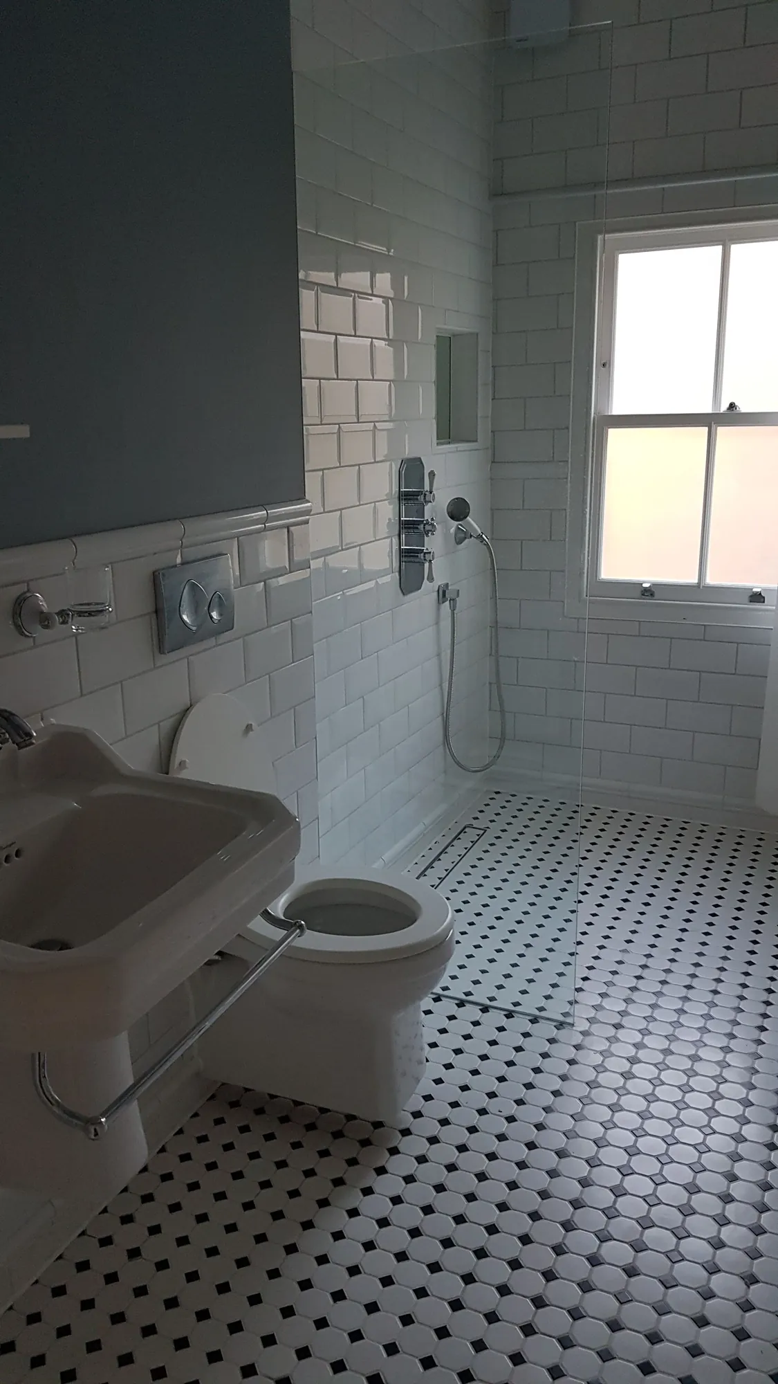 Edwardian style bathroom with metro tiles and a mosaic floor