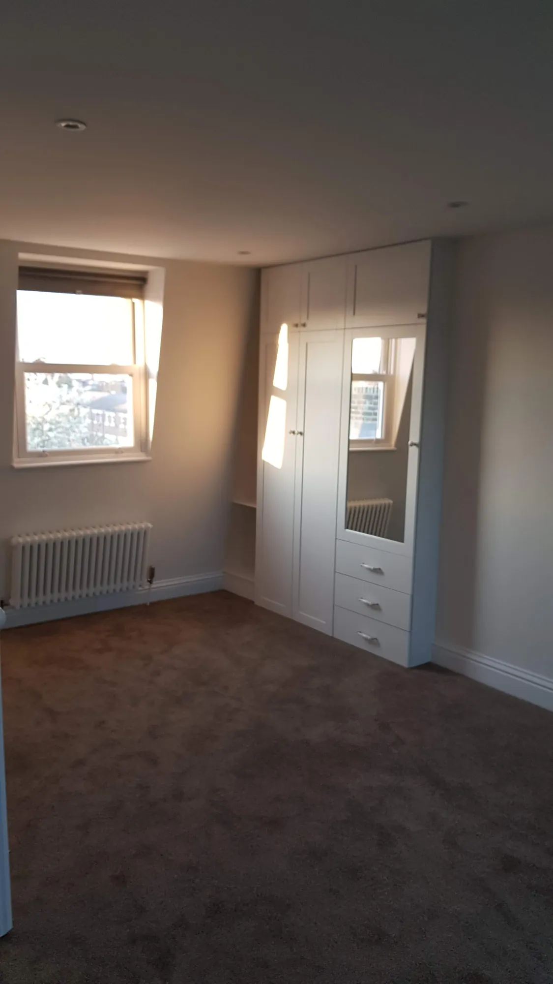 Loft bedroom with a fitted wardrobe